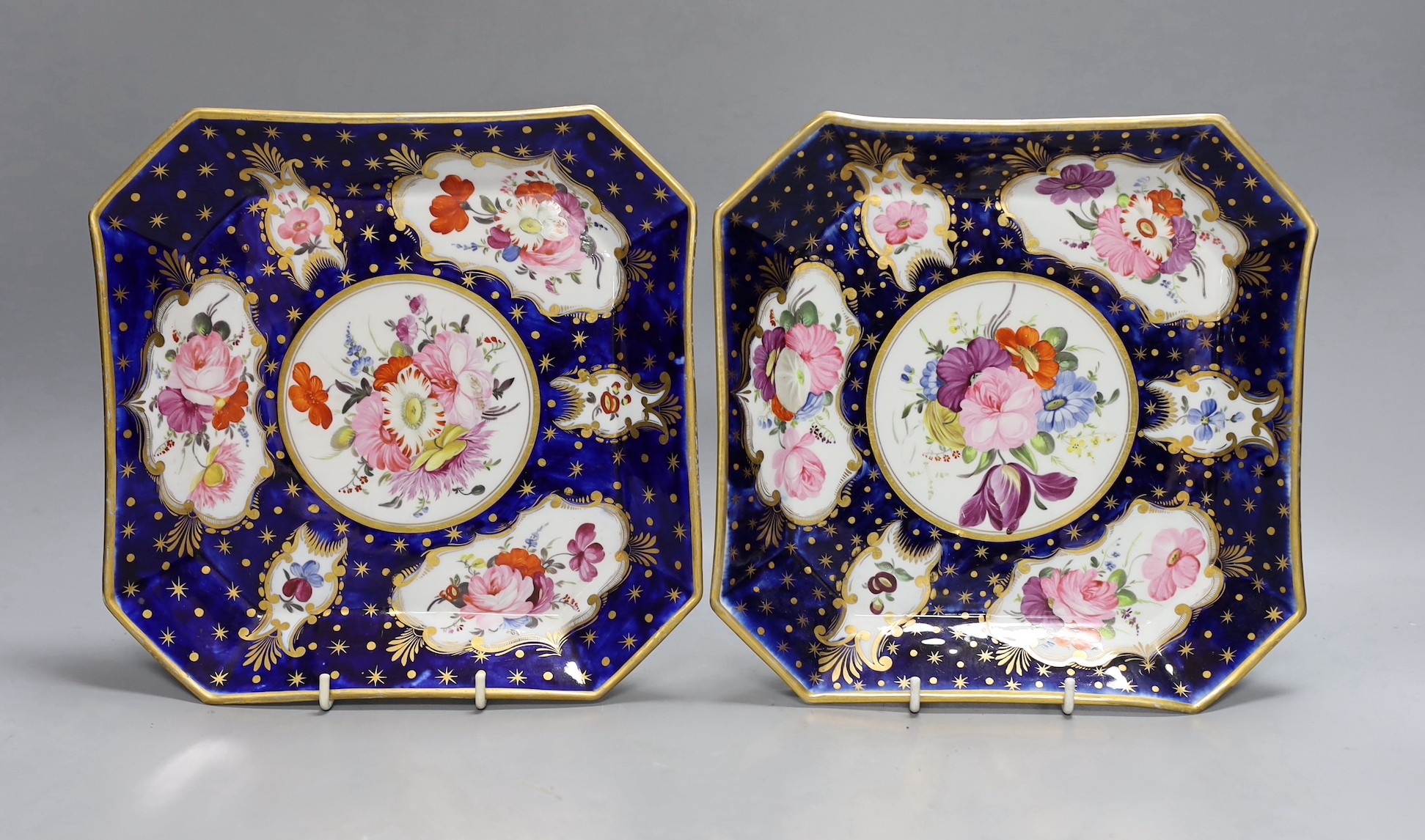 A pair of Coalport ground blue and gilt porcelain square dishes, c.1815-20, with floral panelled decoration. 22cm wide